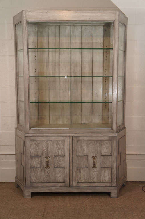 Here is a great cabinet with glass front top and sides and a gray faux bois finish.