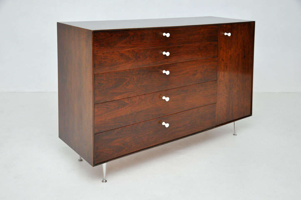 George Nelson thin edge cabinet for Herman Miller. Five drawers and one cabinet. Rosewood with aluminum legs and original white porcelain pulls.