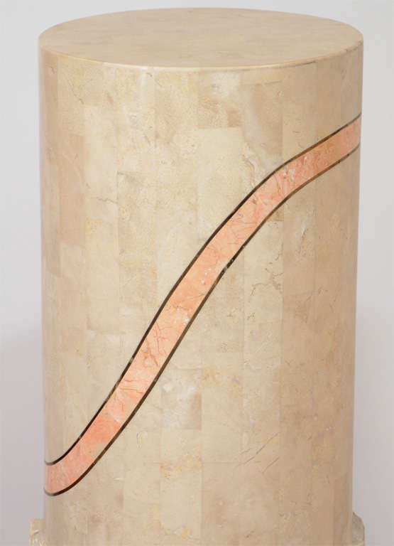A pair of tessellated travertine pedestals by Maitland Smith. Each has a pink, curving stripe and a 