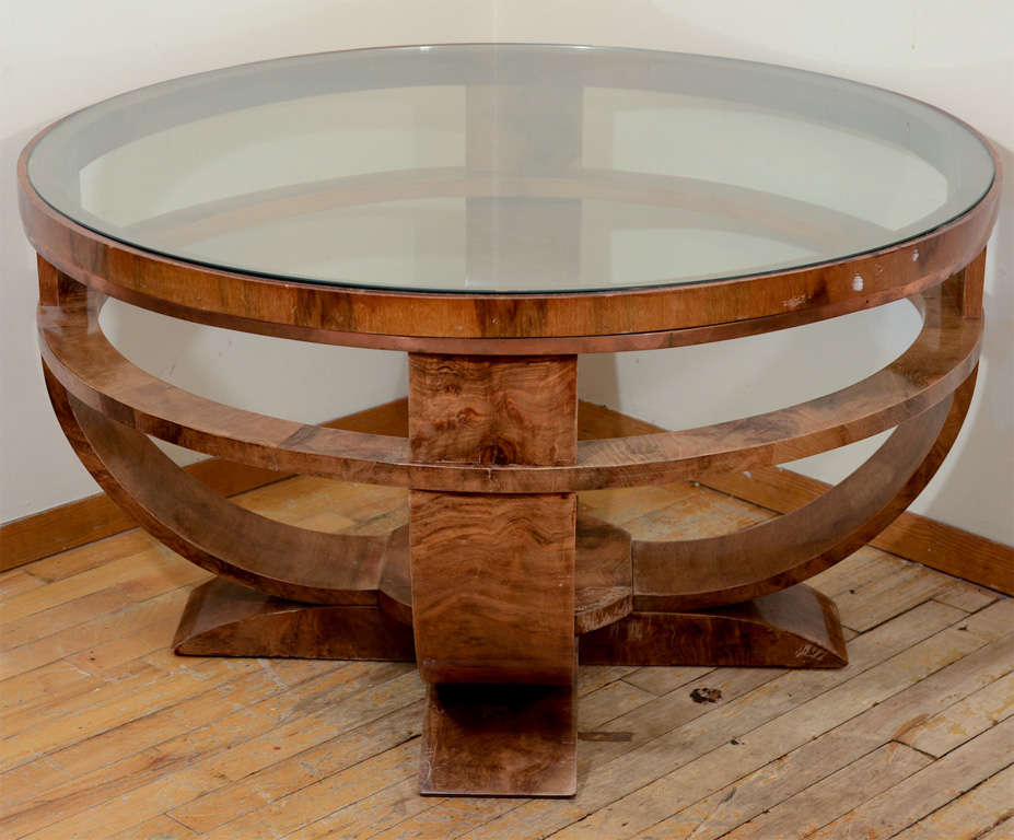 A vintage art deco coffee table in wood with burled veneer and a round glass top.

Reduced from $4200.00