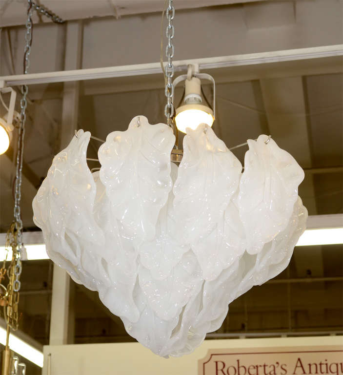A vintage Italian chandelier, produced, circa 1960s by Camer, with curled leaf-form frosted glass panels, suspended from a metal frame. Very good vintage condition, with age appropriate wear.