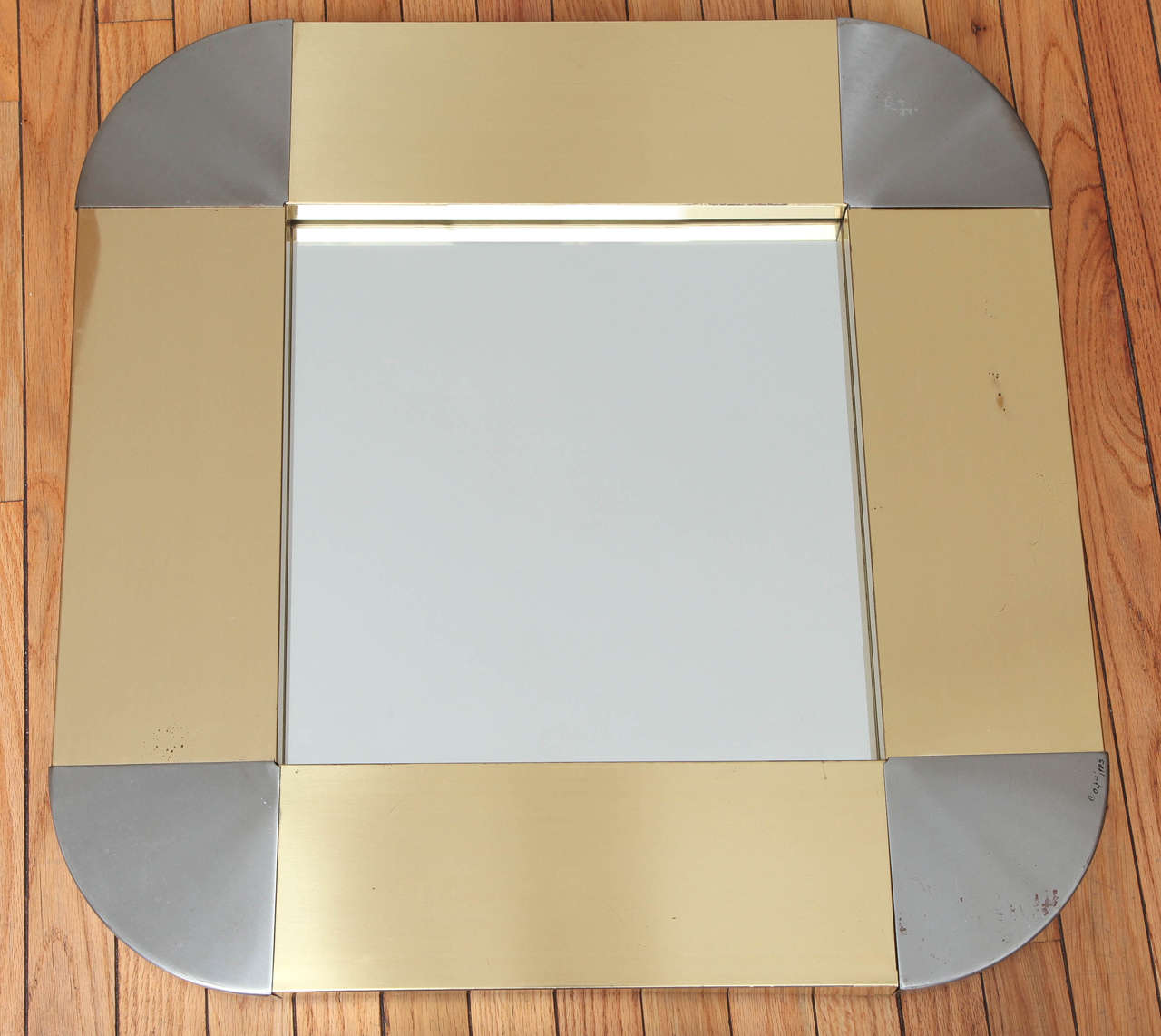 Vintage wall mirror in brass and steel. Signed C. Jere 1983.