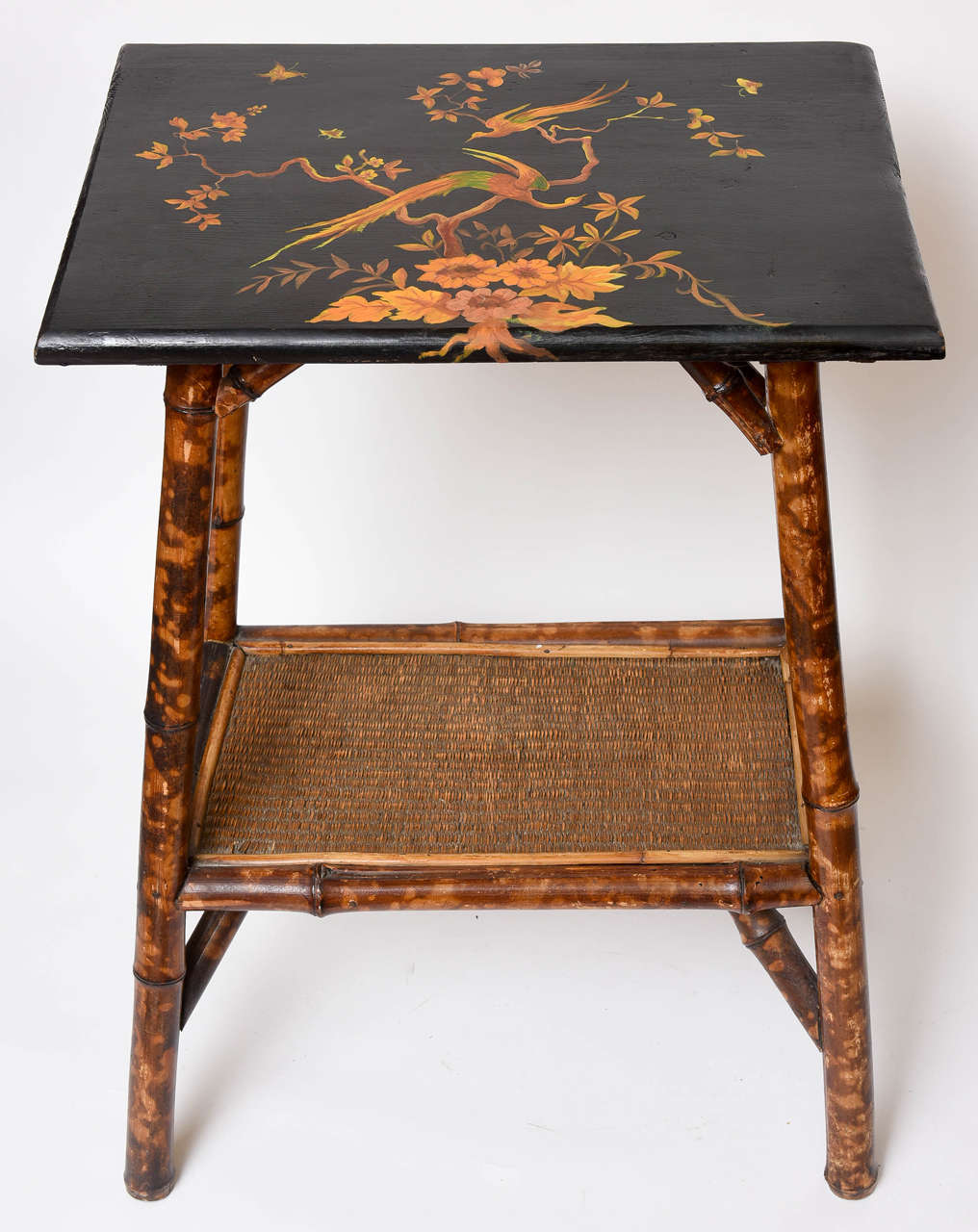 Bamboo table is graced with a wonderful hand painted top displaying birds (replacing original grasscloth).
