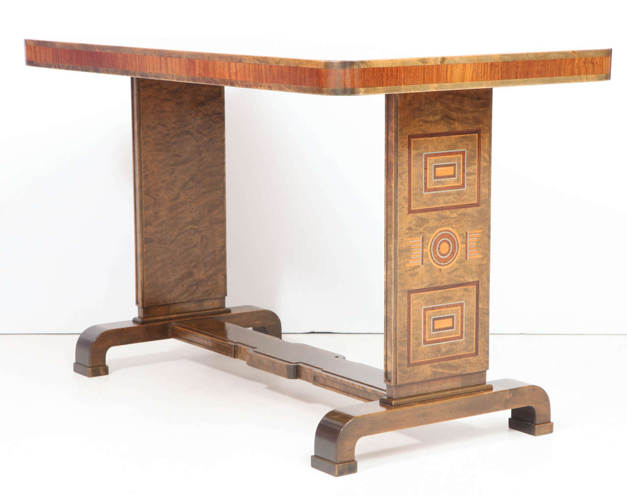 A rare Swedish birch, elm, fruitwood and pewter inlaid center table probably by Carl Bergsten, Circa 1930s, the rectangular cross-banded top with slightly rounded corners raised on two rectangular end supports with unique inlay work, ending with a