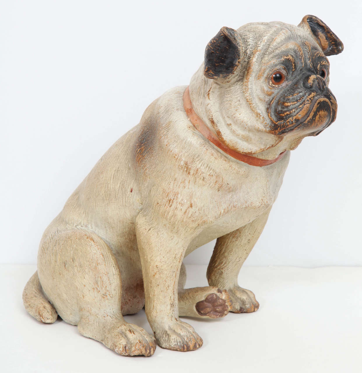 Good painted terracotta seated Pug with glass eyes. Really nice surface and no breaks or chips. This model really catches the character of the breed. Probably produced in Austria, Late 19th Century

 10 1/2 in. x 7 1/4 in. x 11 in.