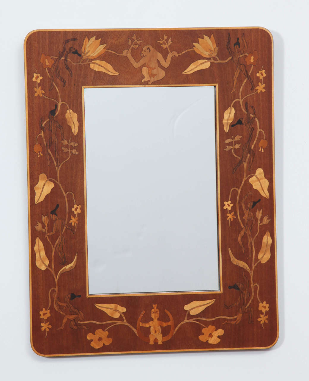 A pair of Swedish Grace inlaid mahogany mirrors, by G. Gerwall, circa 1930s, with a flat frame and rounded corners elaborately inlaid with fruitwood, lemonwood and walnut, depicting flowers, vines, apes and pigmy's. Paper label on verso.