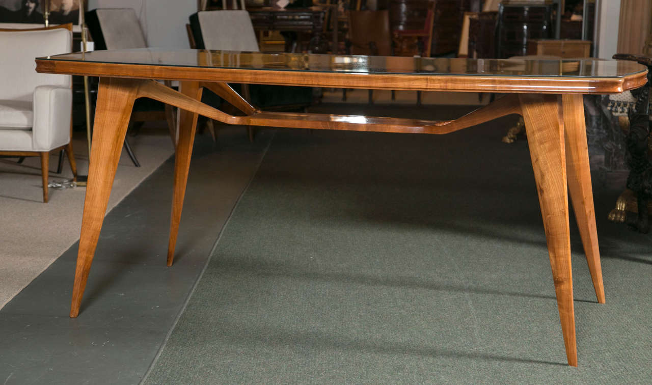 An extremely interesting ash and bleached walnut console table with a free-form cut-out in the tabletop revealing a unique stretcher system. The glass top has been replaced with a piece of tempered glass. 
 Research is still be done to determine