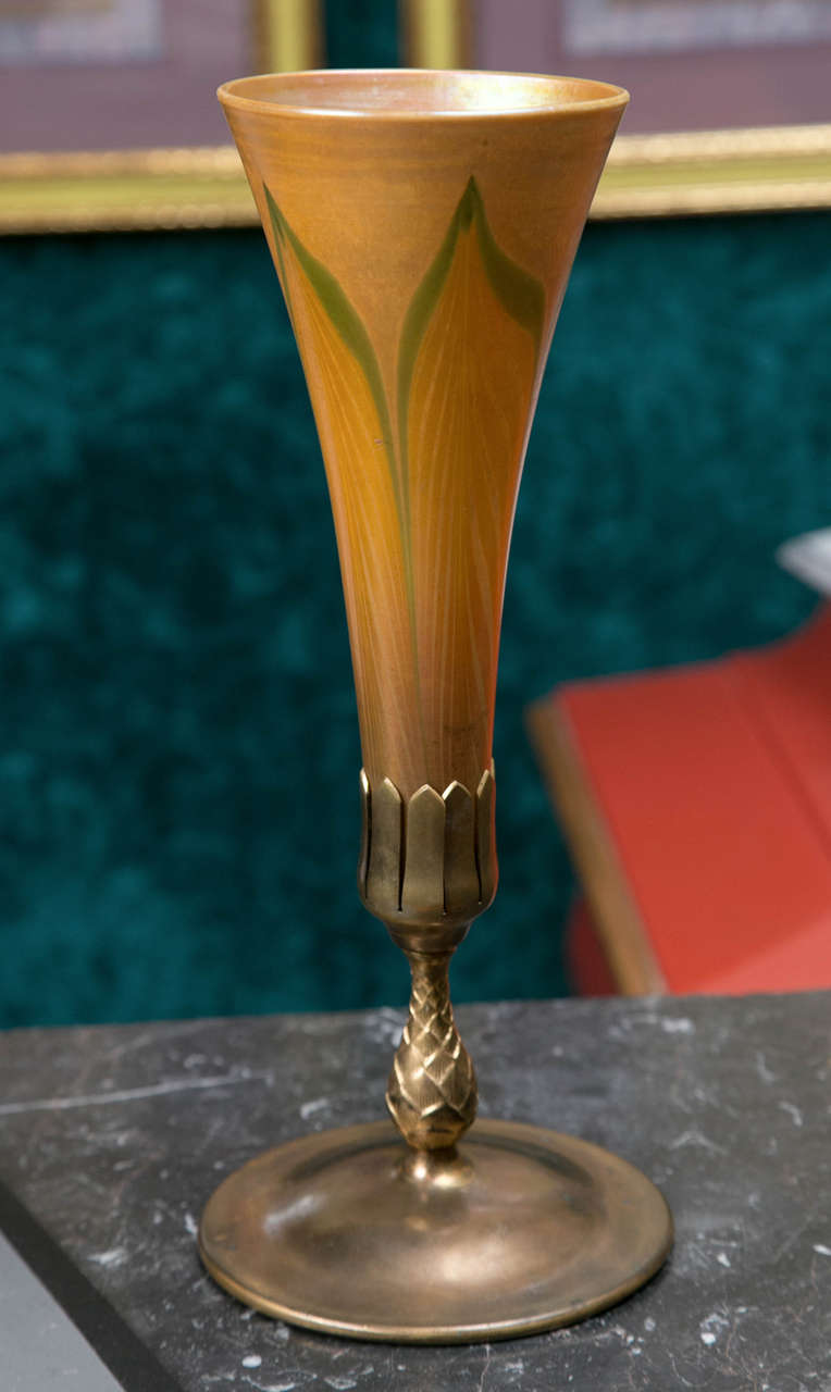 A Tiffany pulled feather vase with bronze mount.