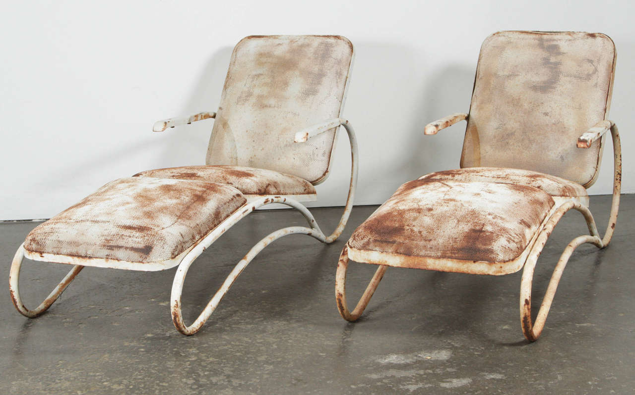 Pair of sculptural iron chaise lounges in the style of Russell Woodard. Modernist mesh details with a strong patina. Made in USA, circa 1950s.