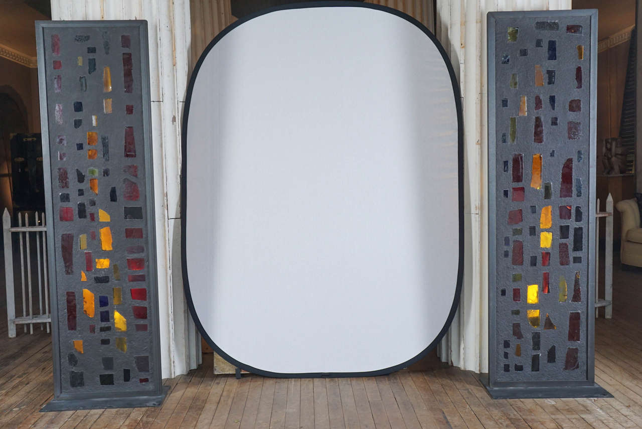 Pair of mid-century modern French window panels - chunks of colored glass encased in cement structure - 20th century interpretation of medieval stained glass - framed and mounted on steel base - stunning

provenance: Robert Altman
