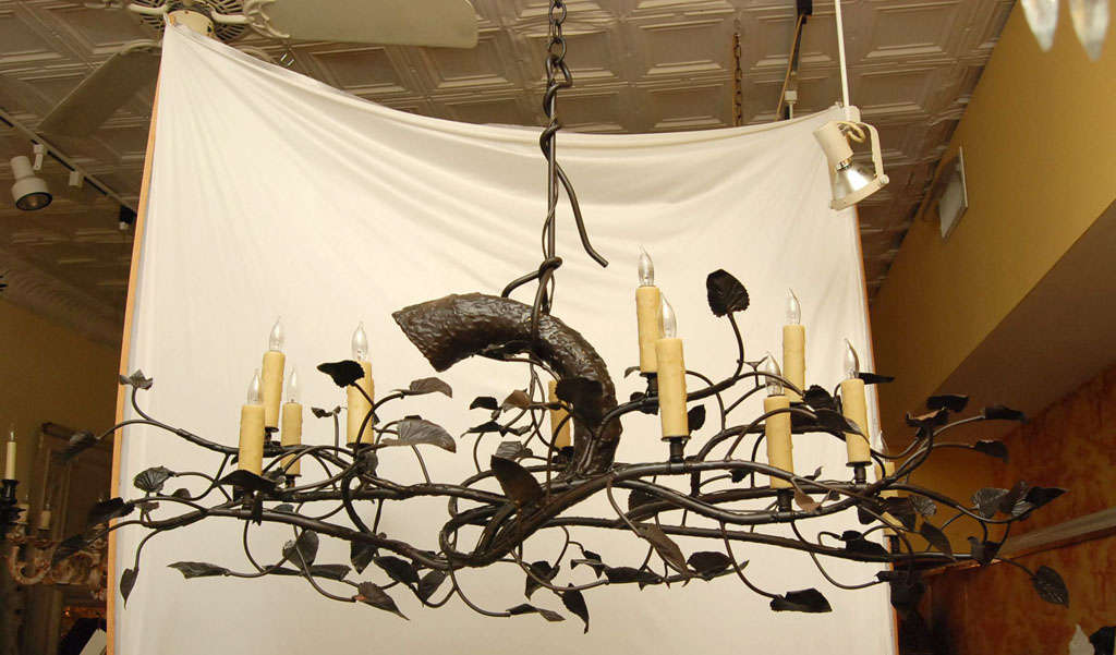 A steel and Bronze Tree branch with 12 lights in a oil rubbed bronze finish. An original one-of-a-kind Cotton Wood Tree Branch Chandelier. Very realistic of a tree branch hung by a tied rope in steel. Hand stamped and shaped leaves and a heavy