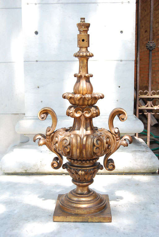 This finely carved and robust Baroque urn made as a lamp standard, though now unwired, was made in Italy. The gilding is very good and shows nice wear and patina with traditional red boulle work underneath the gilding. Made to resemble 18th-century