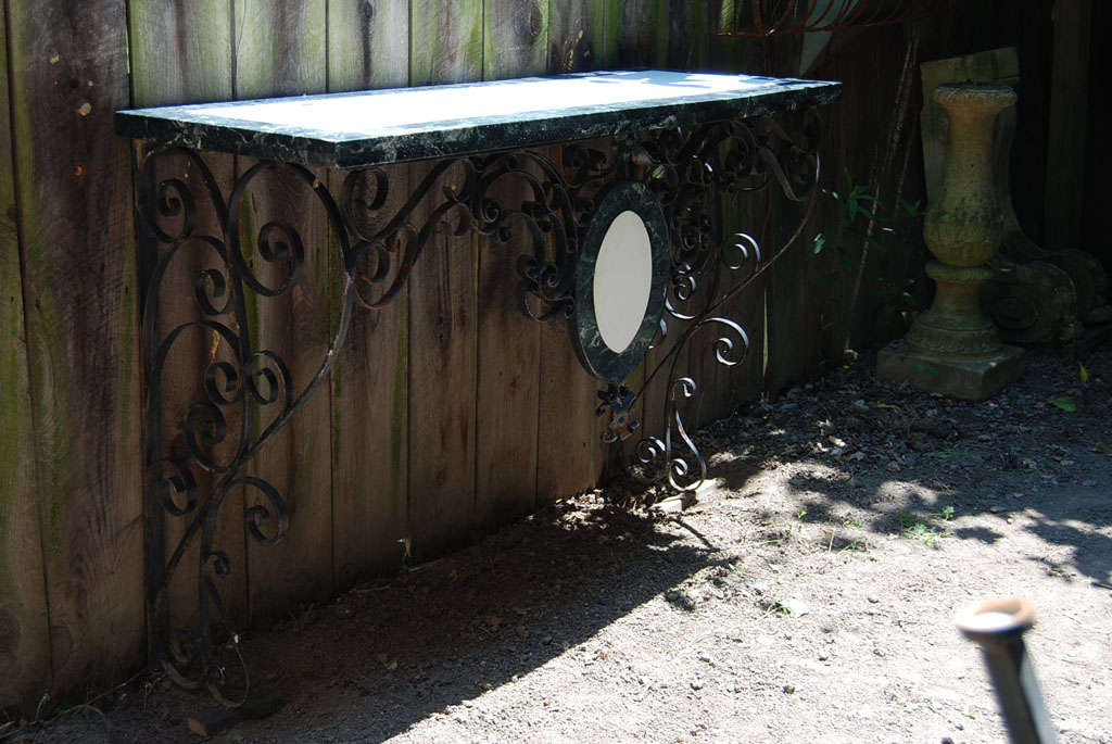 This fine wrought iron wall mounted console table is made up from 18th century parts with early 20th century additions. The 18th-century middle section (see image 6) was probably part of a large wrought iron gate or architectural element and has