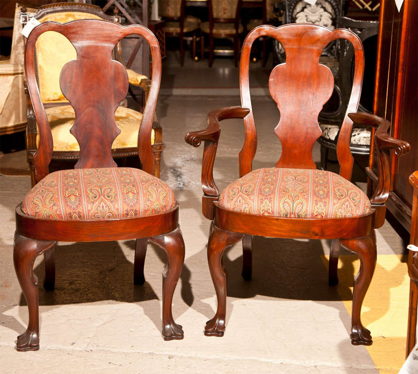 Fine set of Twelve Queen Anne Style Dining Chairs each of solid wood having a finely carved claw foot leading up to a nice high back having very clean and straight lines. Can buy as few as Six or all Twelve