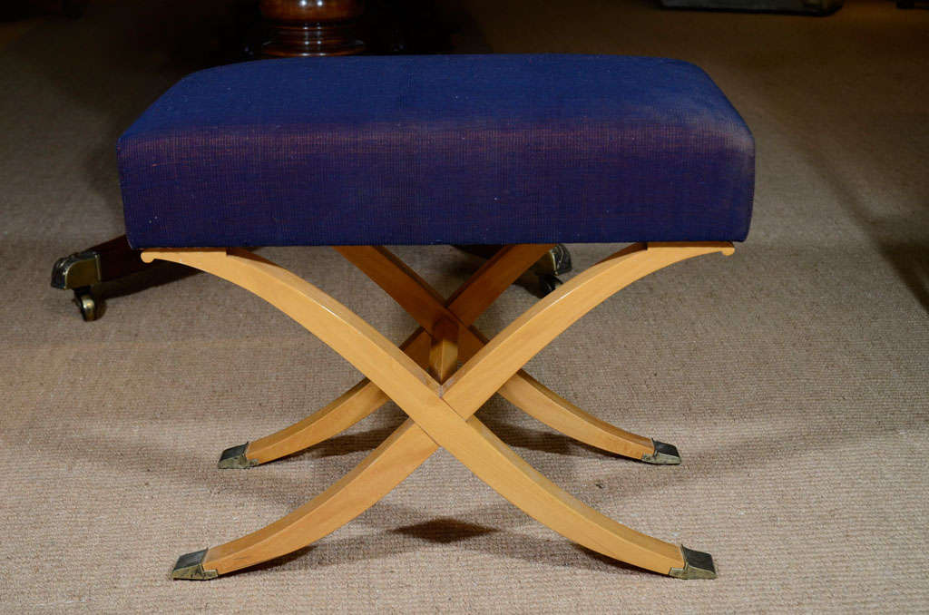 The purple and black weave linen upholstered seats on scrolled x-form satinwood frames ending in brass sabots.