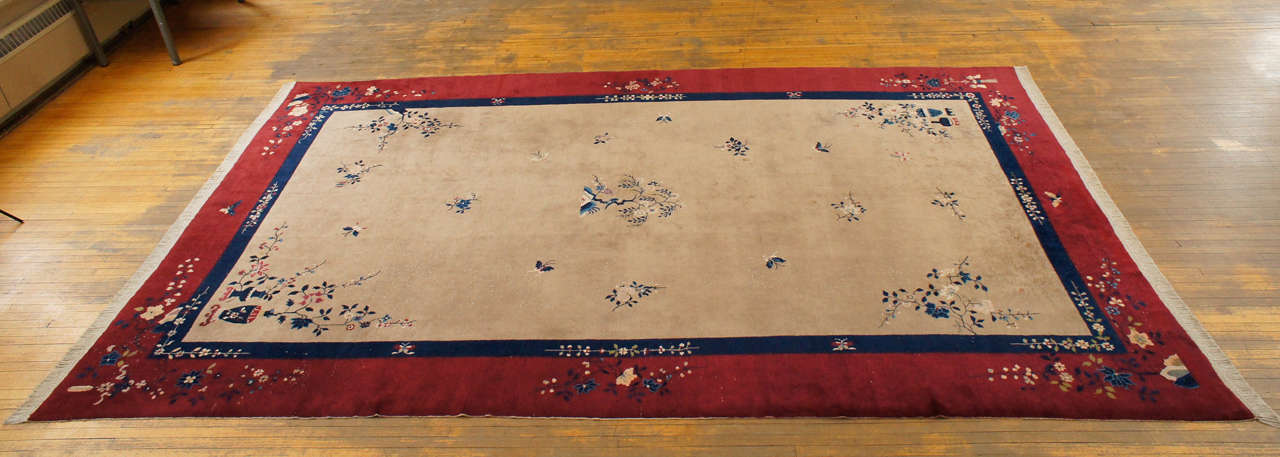 Beautiful Chinese Art Deco style 'Nichols' rug of extremely large size having beige center field, navy blue fillet, and burgundy border, with all-over foliate, tree, vase, and butterfly designs.