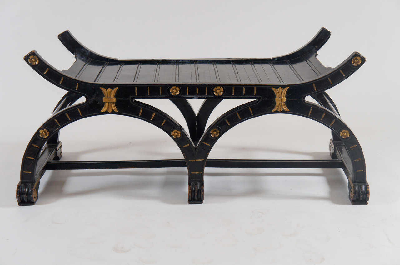 Beautiful Russian circa 1860 parcel gilt and ebonized hall seat or bench having beaded-edge plank top or seat and double curule form base with front having carved flutes and rosettes, and applied carved wood stylized 'fleur-de-lis', on scroll-foot