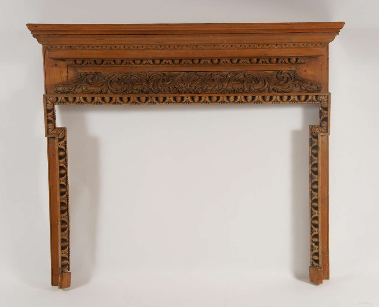 Beautiful late George II, early George III carved pine and lime wood fireplace mantel having Rococo foliate carved lintel with egg-and-dart under shelf and around opening.  Opening measures 45.88