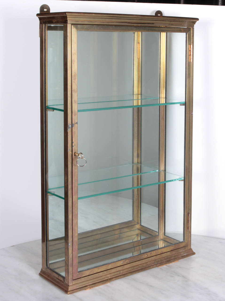 Exceptionally fine and rare bronze wall cabinet with mirrored back and glass shelves.  Made in Provence, France circa 1900.  With original key and working lock mechanism.  Perfect for an elegant bathroom.