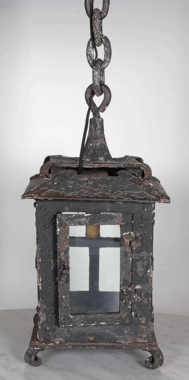 Extremely early cast iron hanging lantern of the finest workmanship of the era. Has a unique and impressive canopy and a fabulous original distressed and weathered finish, American, circa 1910.

Height with chain and canopy - 32.5