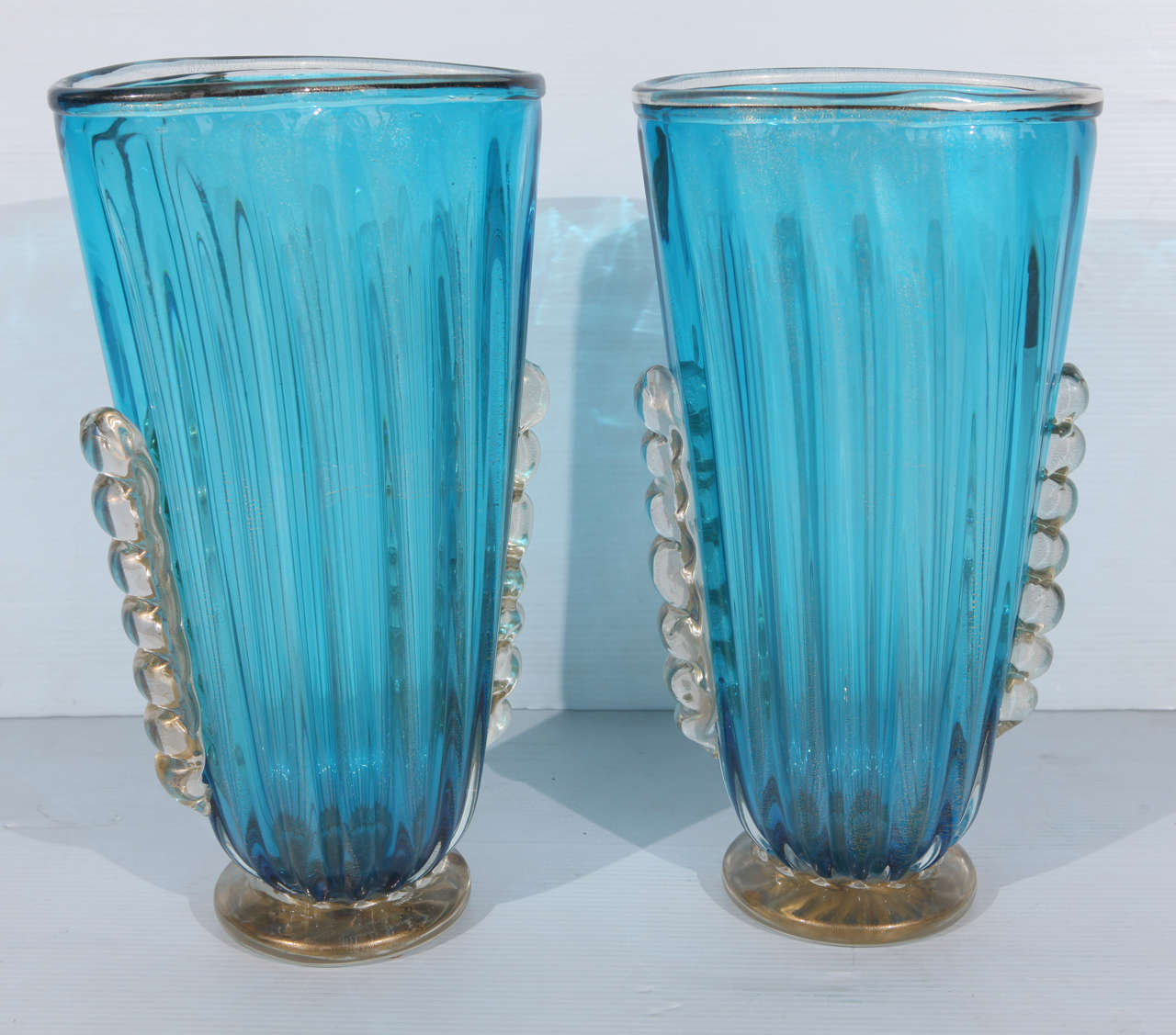 Beautiful Pair of Aquamarine Murano Vases with infused  gold  flecks
Signed Alberto Dona

Alberto Donà was born in Italy in 1944. Alberto_Donà
He began working in the glass field at the age of 13. He worked with many masters and had the