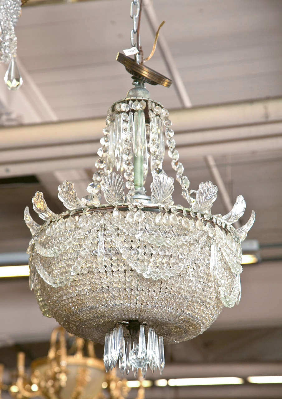 Gorgeous, all original antique glittering crystal beaded chandelier.The beading graduates in size from petite carats to larger perfect baubles of light. The ball finial is also beautiful and rare to find. It is surrounded by acanthus leaf crystals