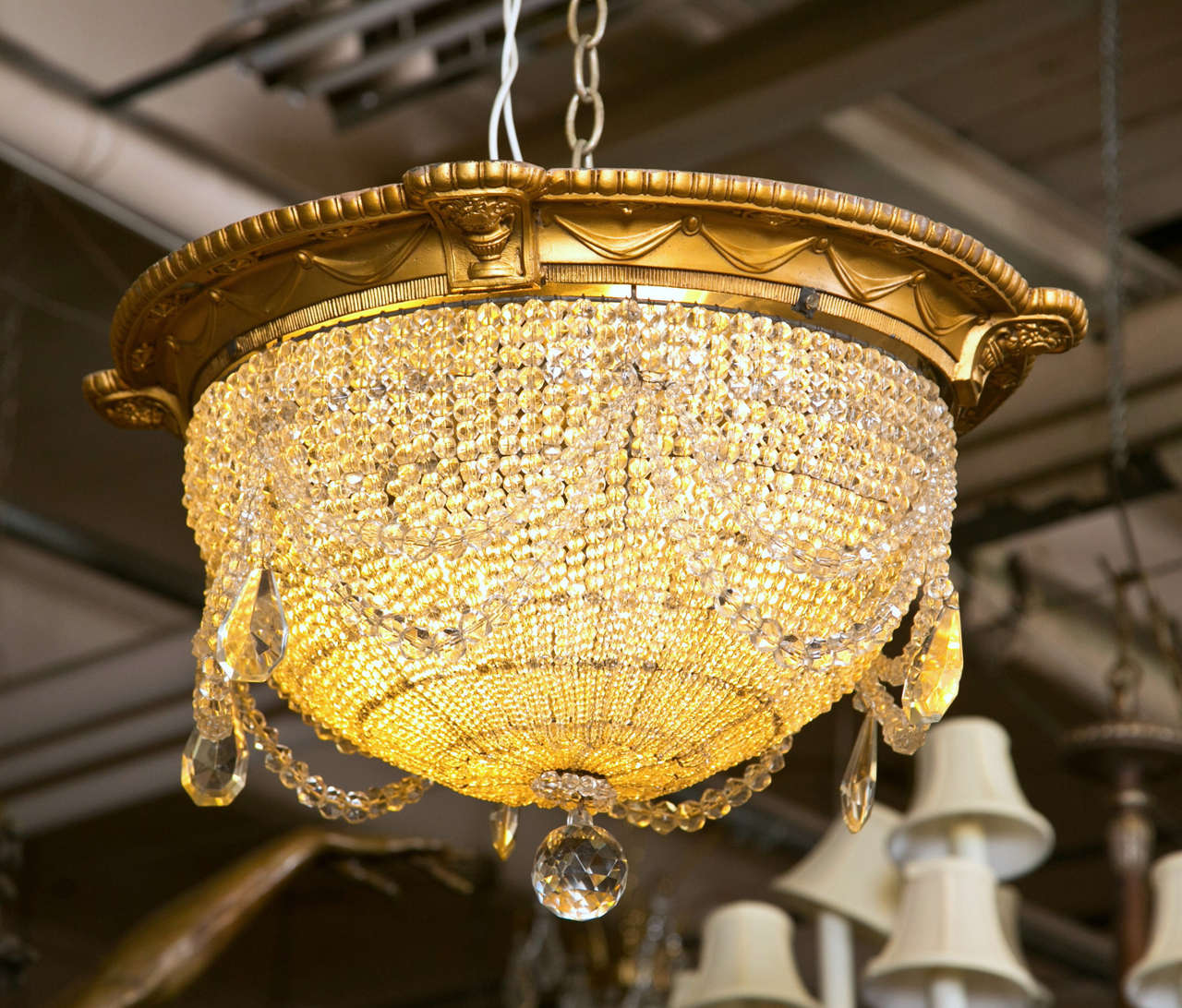 Gorgeous ceiling mount fixture.  All original antique crystal beaded dome chandelier.  The beading graduates in size from petite carats to larger perfect baubles of light. The top has a beautiful brass finished white metal ring rimmed with filigree.