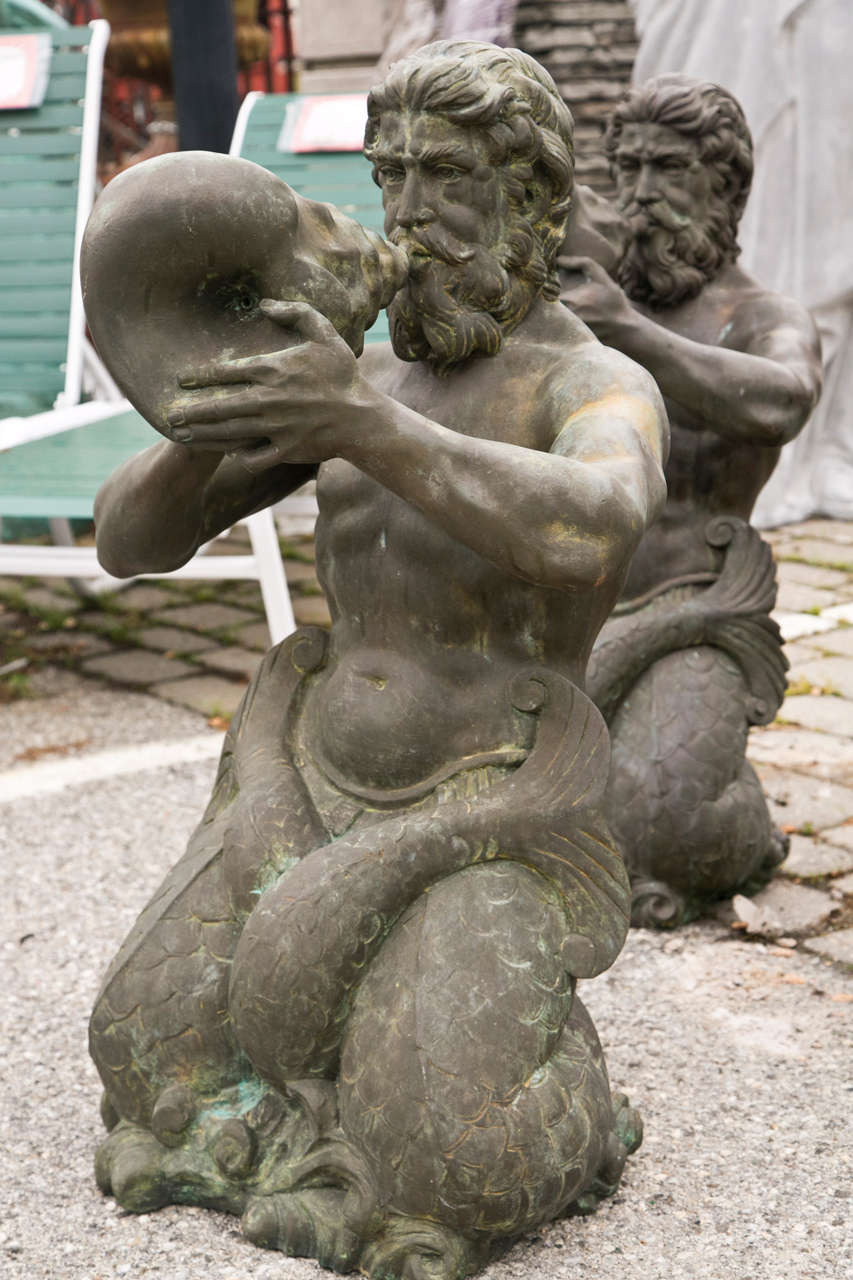 These Mermen are art sculptures blowing conchs.  These men are bronze, kneeling with water spitting out of the conch shell.  Each merman has a wonderful patina from years of being used in a fountain.
These outdoor nautical sculptures make a real