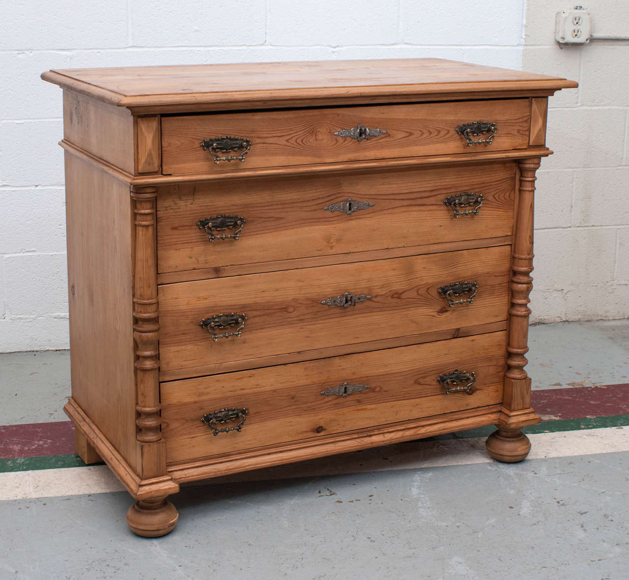 This is an outstanding pine chest of four hand-cut dovetailed drawers flanked by turned split balusters.  It is sturdy and heavy and is beautifully constructed with all the features we like to see in a late nineteenth century German chest.  The