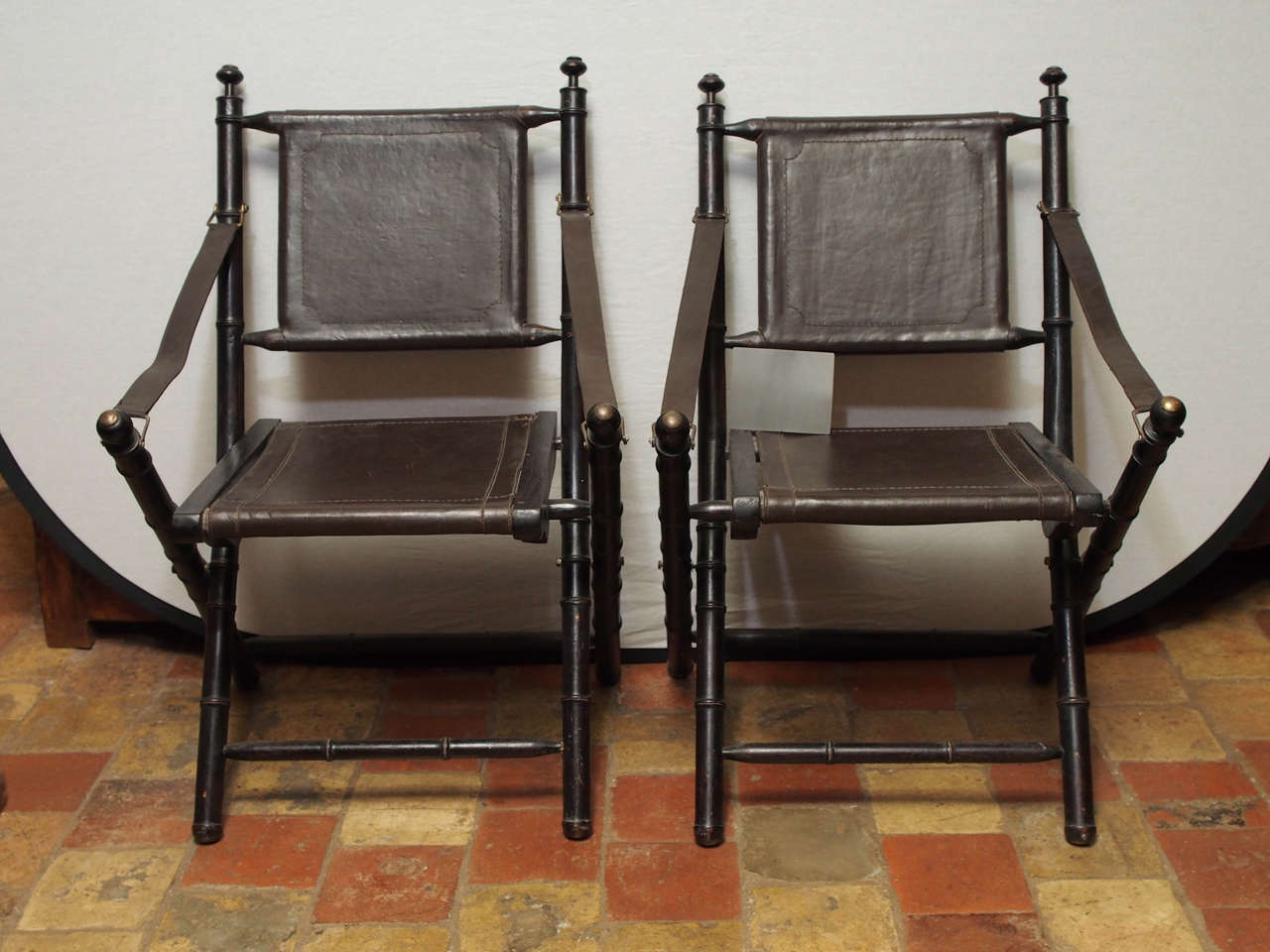 19th century French leather folding Campaign chair with painted wooded frame, circa 1890. These type chairs were used in outdoor events such as safaris.