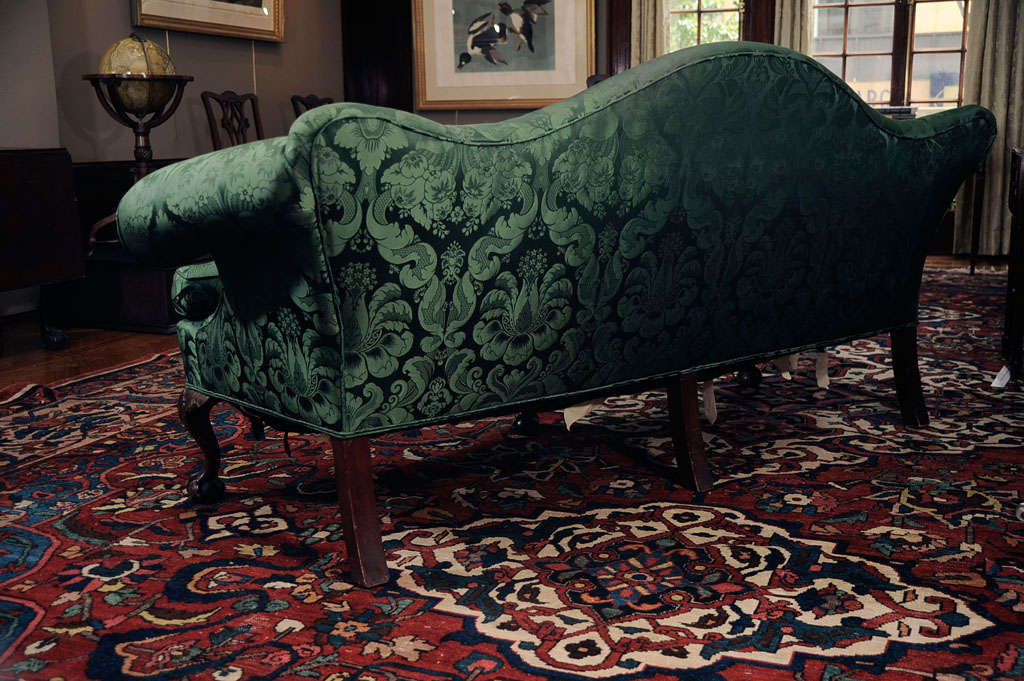 A Carved Mahogany and Upholstered Camelback Sofa For Sale 2
