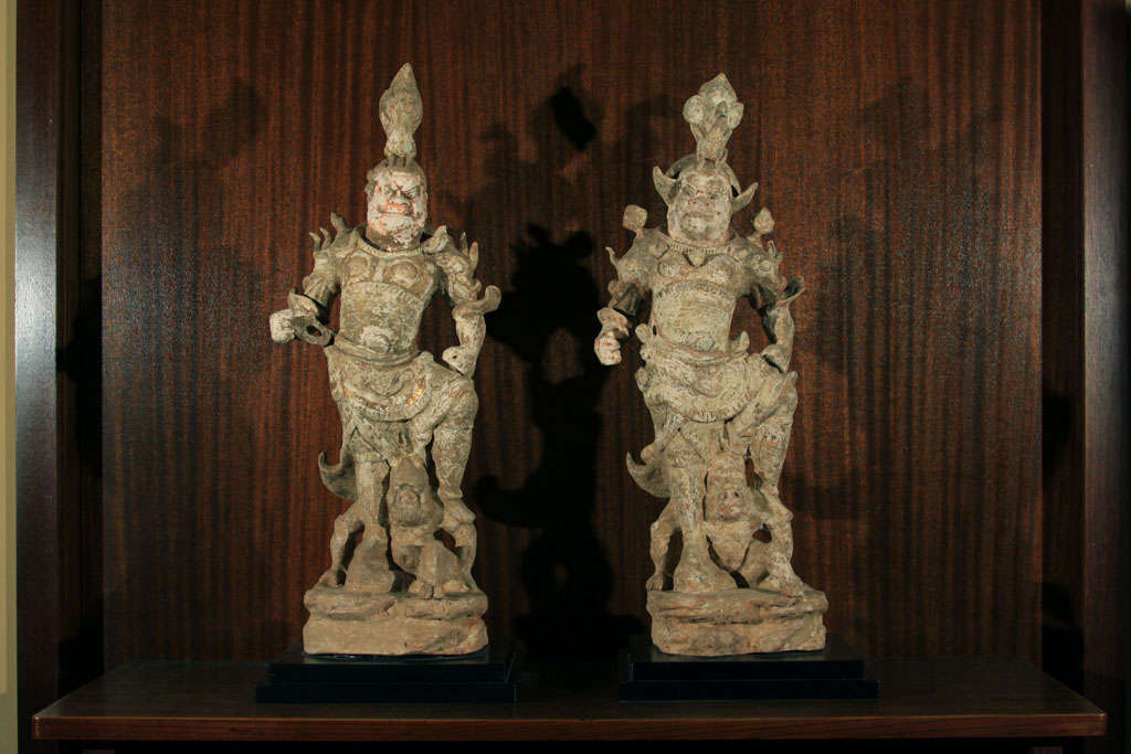 A pair of Chinese earthenware Lokopala (T'ien-wang). These two Lokapala represent two of the four Guardian Kings, who in Buddhist thought are believed to protect the four cardinal points. Believed to dwell on Mount Meru at the Gate of Paradise of