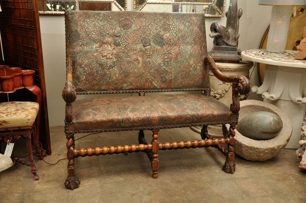 Lot - A LOUIS XIV STYLE FAUX LEATHER UPHOLSTERED WALNUT CANAPÉ