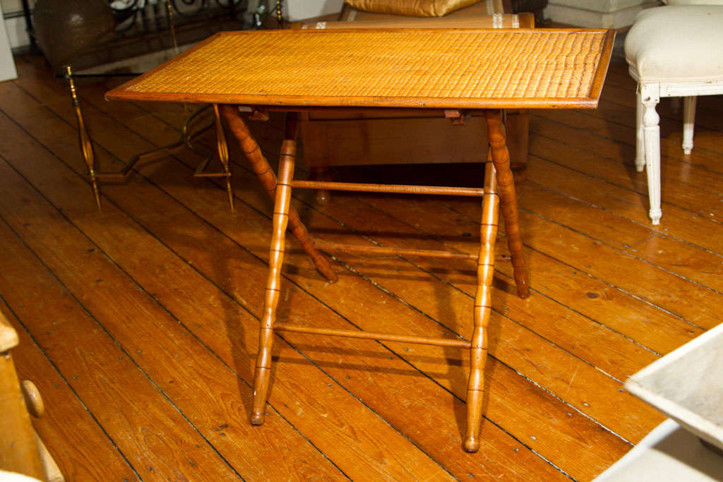 This table from the Southwest of France is beautifully made and in excellent condition. The finely-woven top is backed with pine and features a wooden lip all around that could accept a shallow glass top if you like. A warm and mellow color, it has