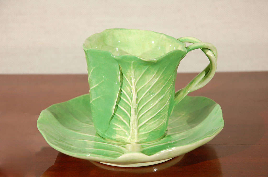Dodie Thayer Cabbage Leaf Cup and Saucer, 1960s.  With Pineapple mark, signed Dodie Thayer, Palm Beach. There are 6 available. <br />
Cup:  H: 3 ¼”   D: 3”<br />
Saucer:  H: 1 ¼”   D: 6”