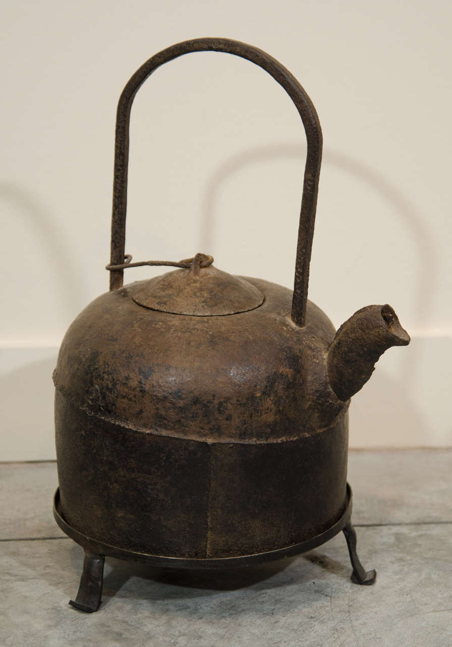 A late 18th Century Chinese cast iron teapot with custom made iron stand. 
M603