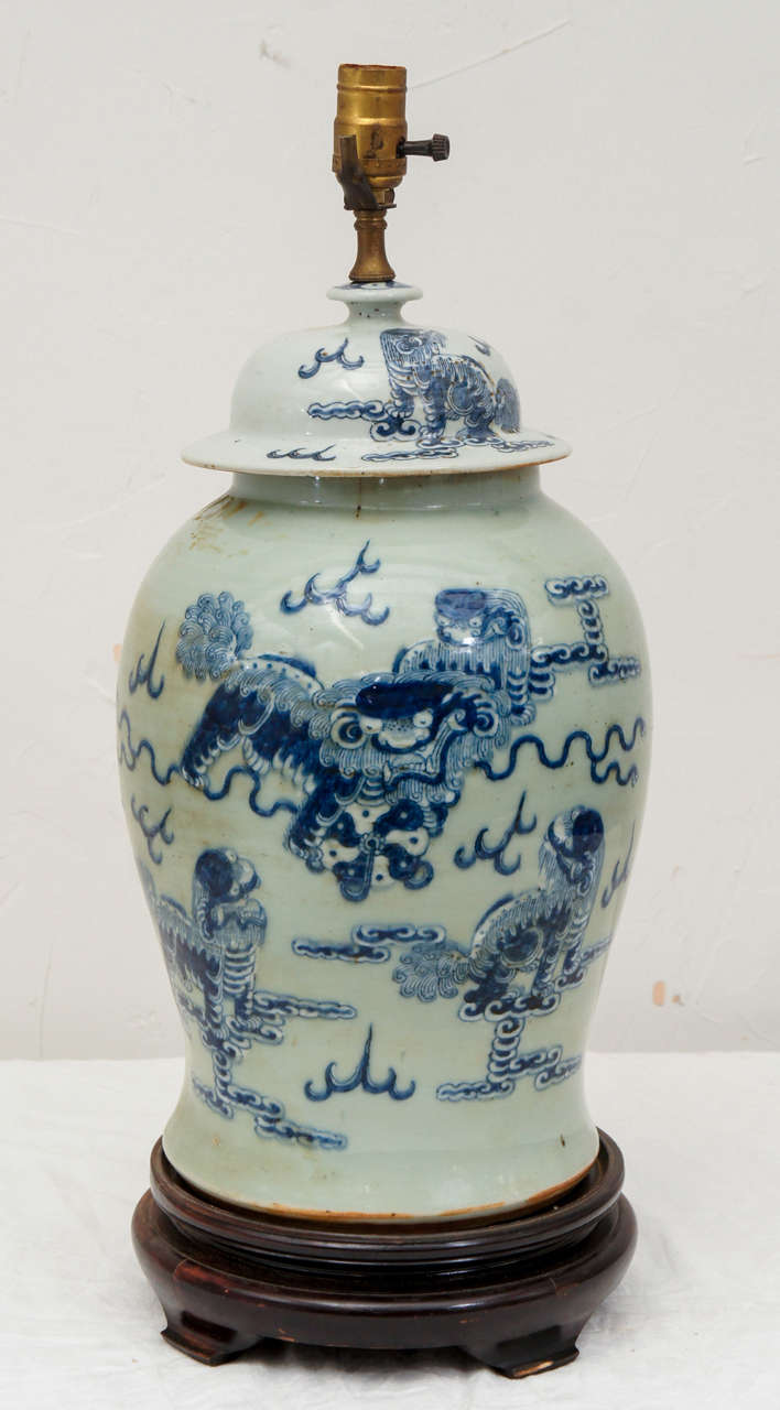 Large antique blue & white porcelain Chinese temple jar lamp with cobalt blue Fu Dogs on celadon background and teak base.  Electrified for regular US light bulbs.  Height includes socket.