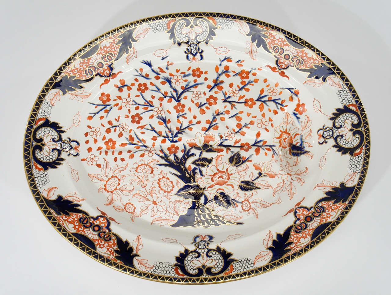 This a large and impressive 19th c. well and tree platter made by Royal Crown Derby in the familiar Imari pattern of cobalt blue, bittersweet orange and decorated with a gilt trim. The colors make it easy to blend with any Imari motif whether made