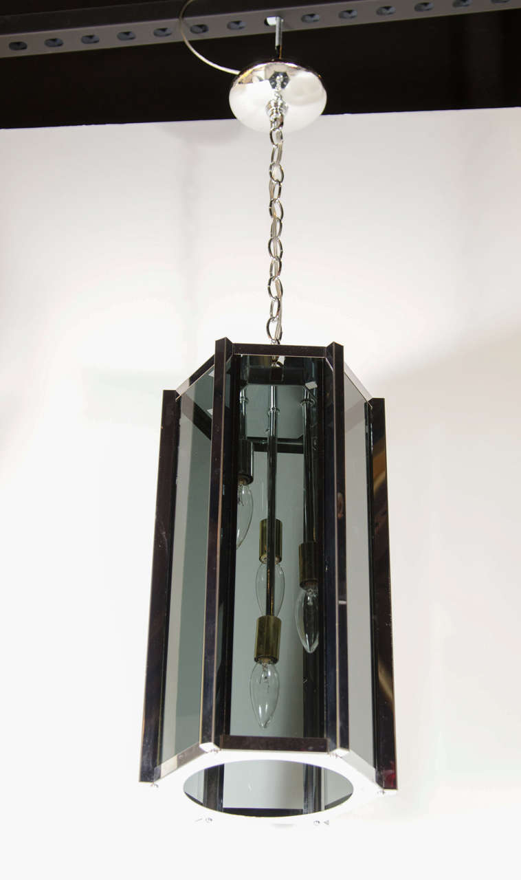 Mid-Century Modern hexagonal shape pendant chandelier designed by Frederick Raymond with six smoked glass panels in a chrome frame with brass fittings. Newly rewired, four lights total and height can be adjusted.