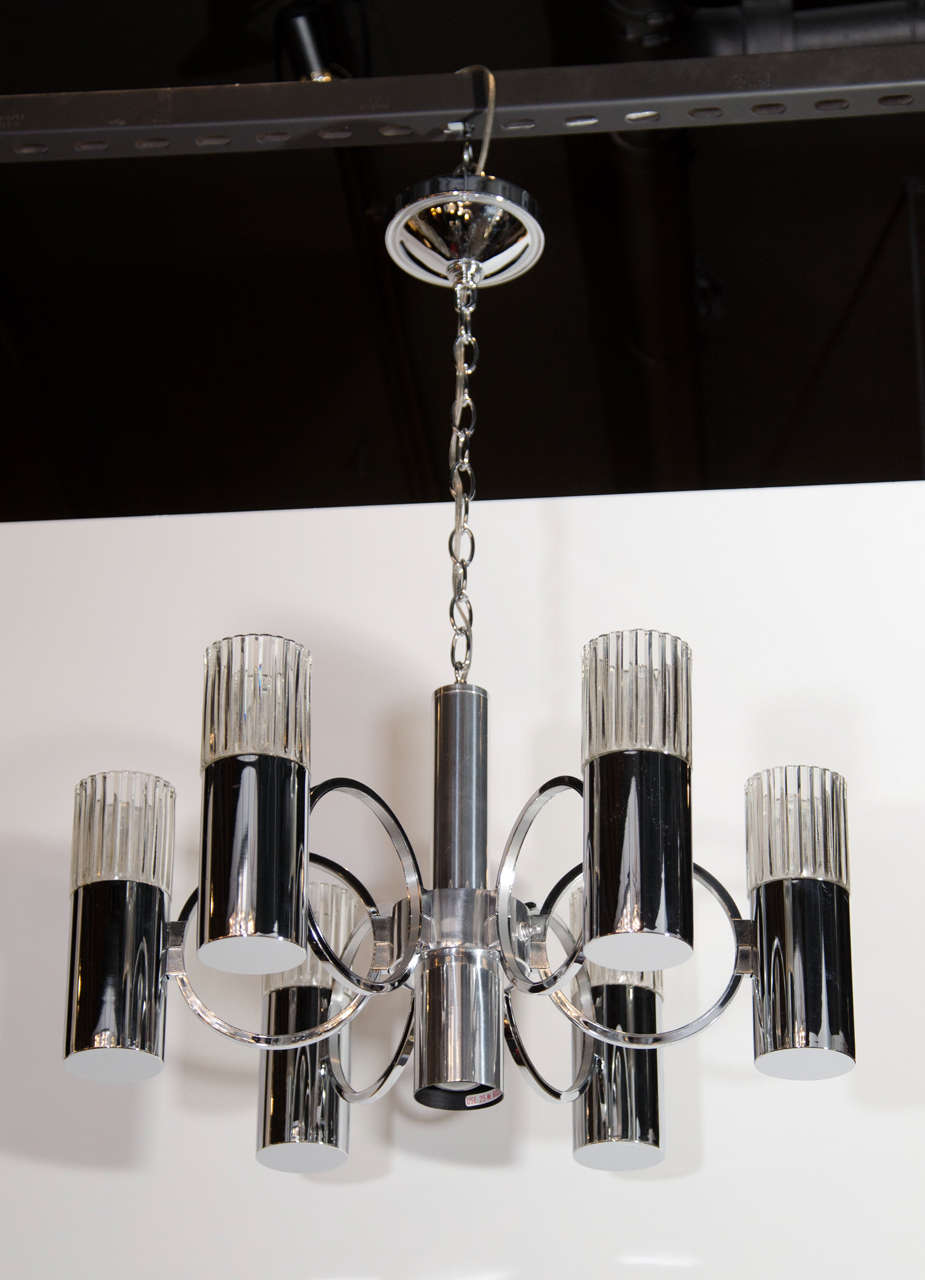 This stunning Mid-Century chandelier by Sciolari features six cylindrical chrome light fittings with ribbed glass shades suspended by rings emanating from a central stem. Newly rewired and the height can be adjusted.