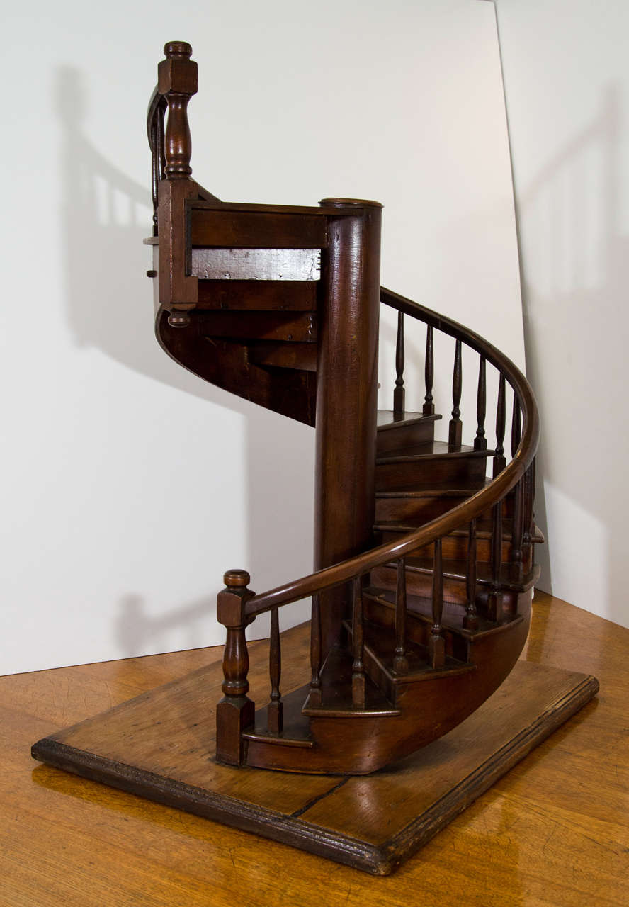 The stairs resting on a rectangular pine base. 