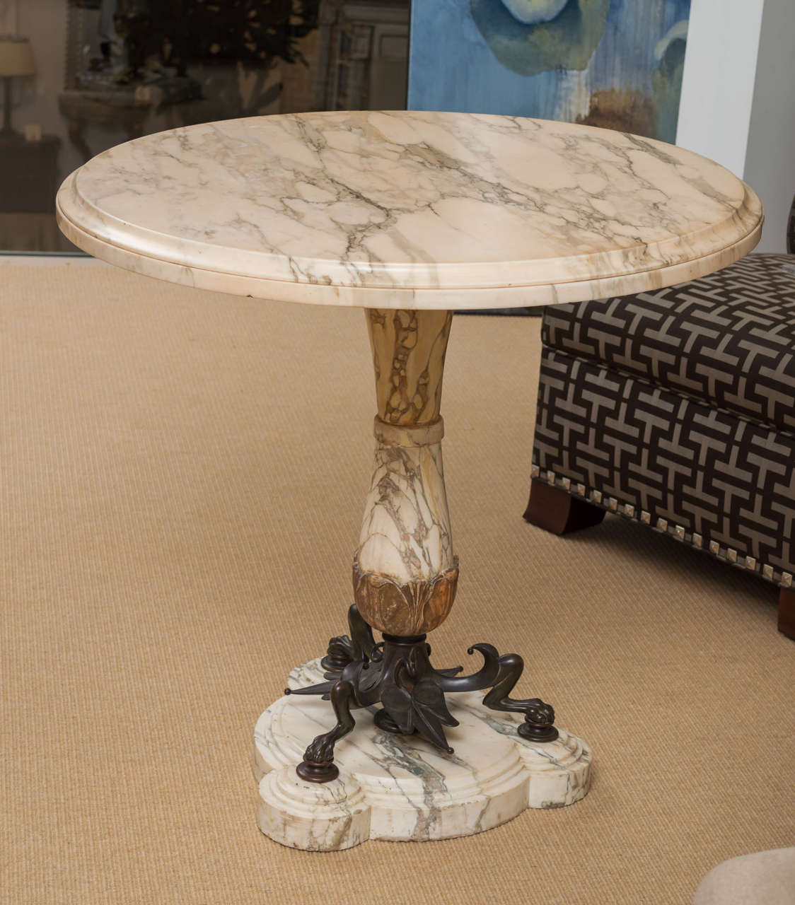 Mid-19th century highly figural faux-marble and bronze Louis Phillipe French pedestal center table with stylized raised tripod and faux marble base supporting beveled edge tabletop.