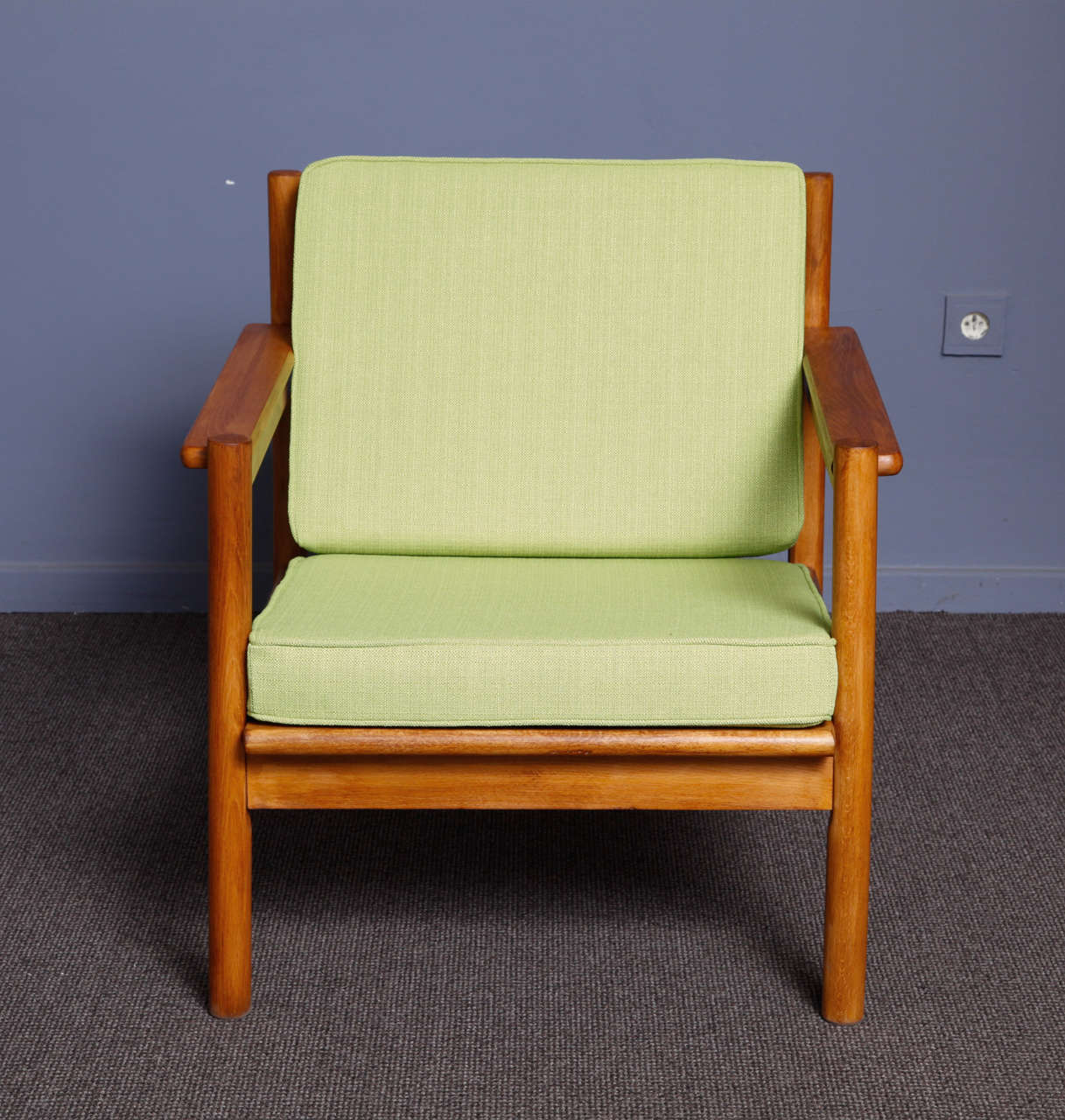 Scandinavian origin Teak wood armchair . Very comfortable ,a model easy to place in a living room or even a bedroom. The wooden part was recently re polished and the upholstery is new. Very elegant green coloured fabric.