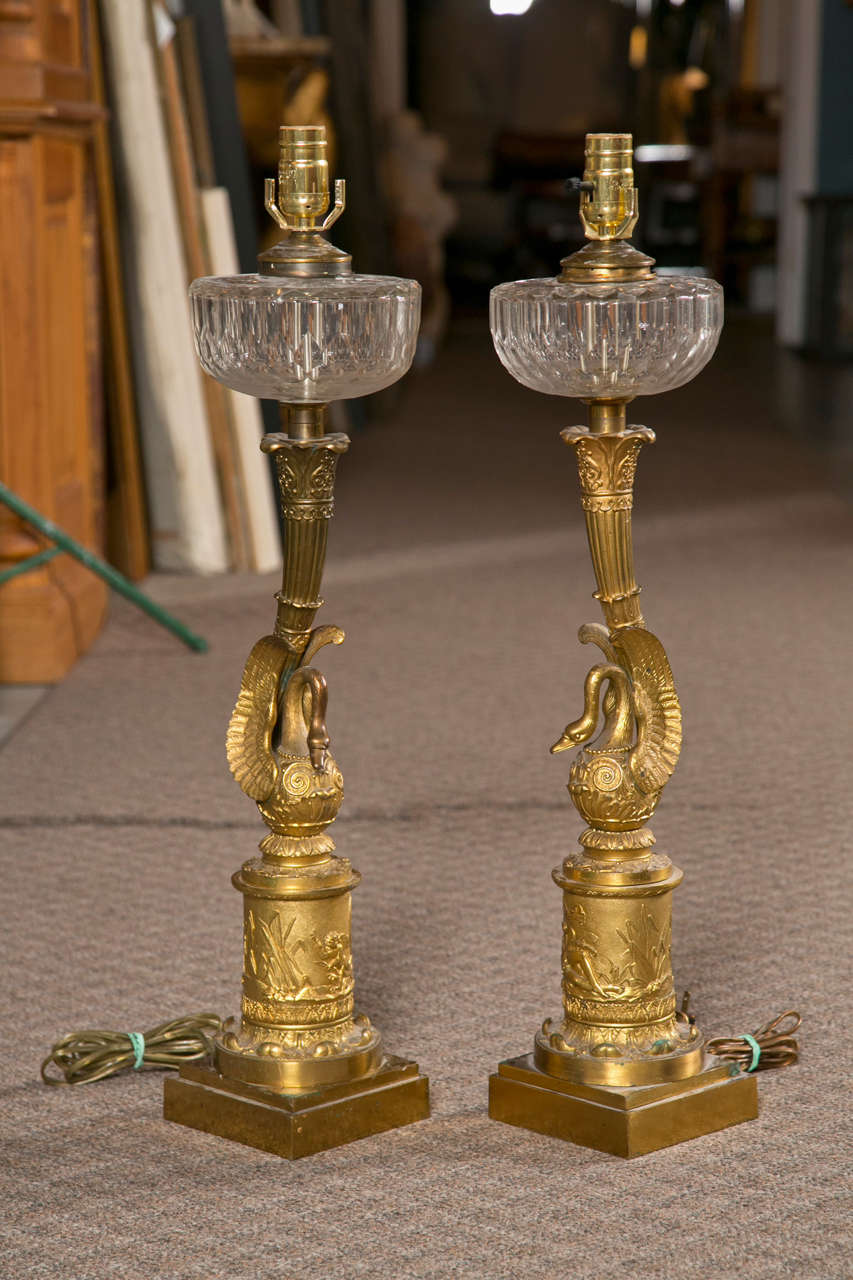 A pair of Empire bronze swan lamps, circa 1800s.