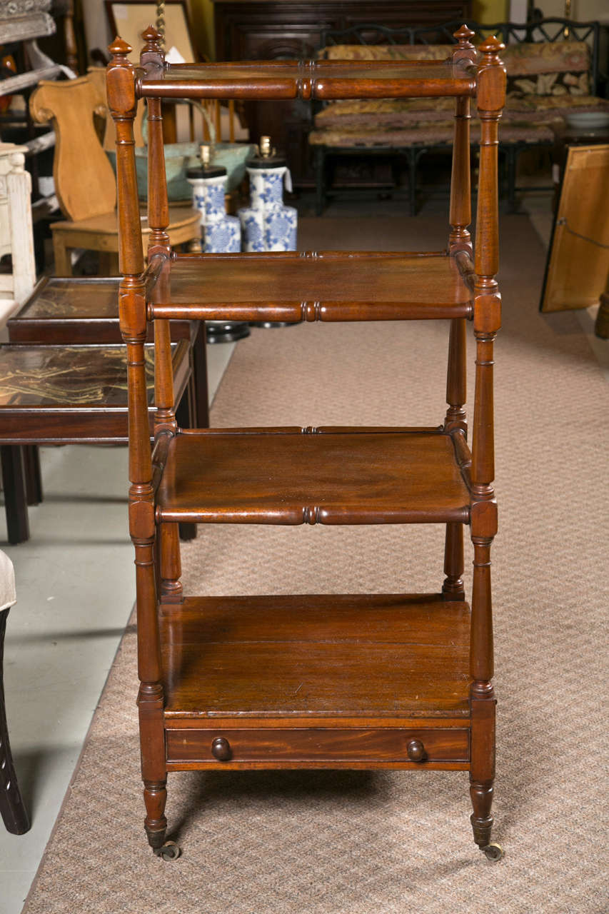 A beautiful English Etagere Circa 1840. Features a drawer on the bottom shelf.