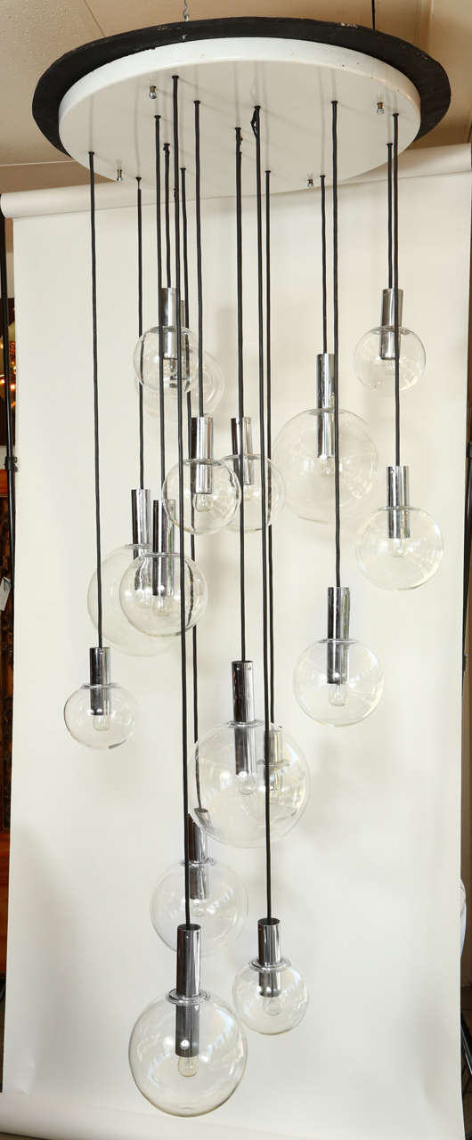 Giant sixteen-globe chandelier by RAAK. The chandelier comprises of four various size clear globes, the largest being 11