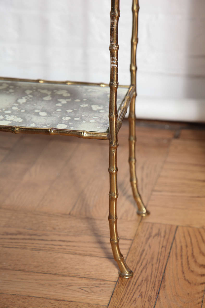 A Gilt Brass and Antiqued Mirror Faux Bamboo Etagere Table. France c. 1950 1