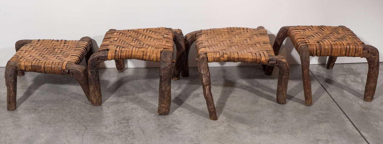 Four rarely seen Tibetan stools with unusual legs and woven seats. Stackable. Sold individually. Tibet, circa 1920s.