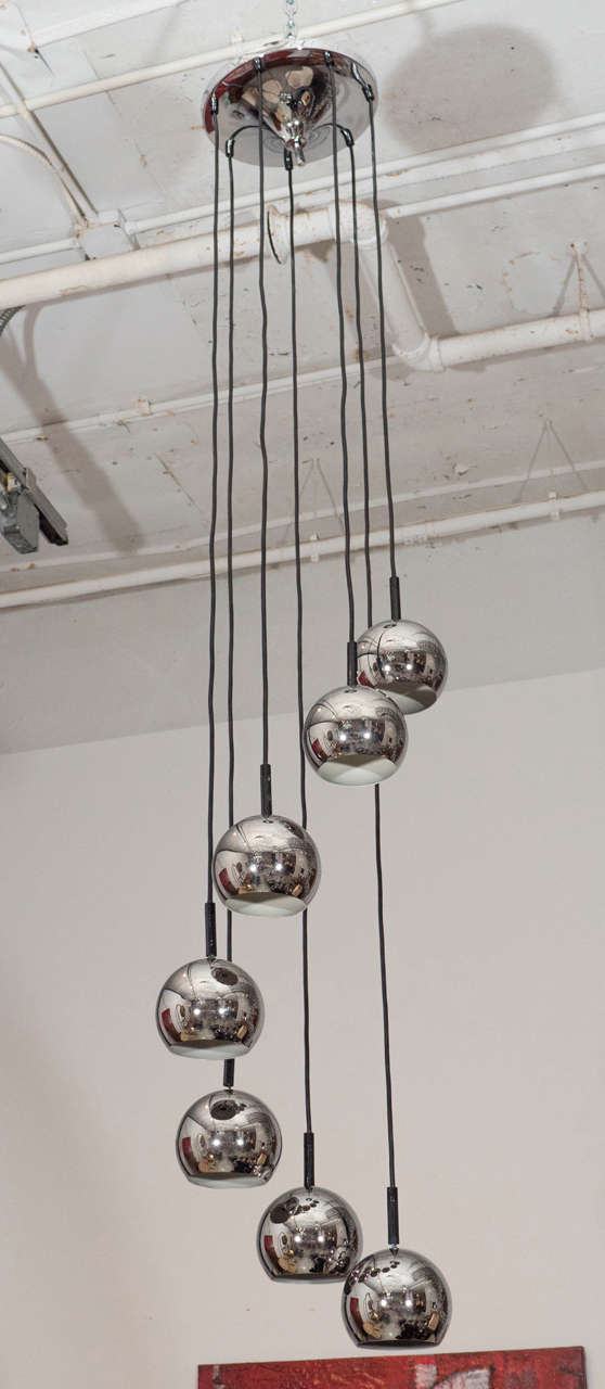 Great ceiling light with seven dangling globes. Length is 67.5