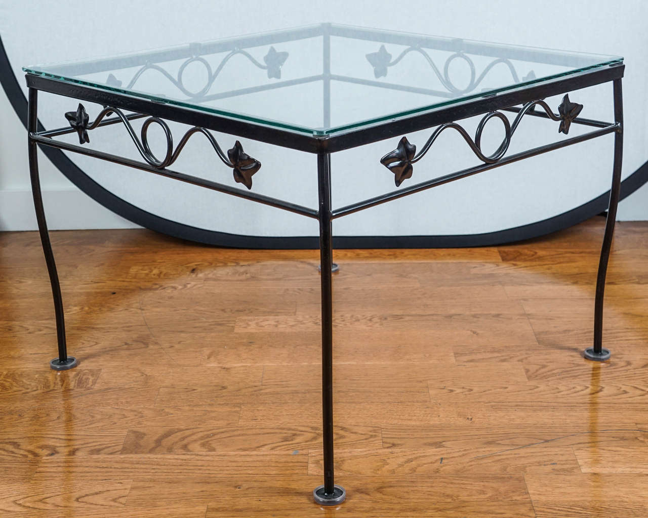 mid century, newly painted, wrought iron, glass top side table, in a charming, scrolled leaf pattern.
pairs nicely with matching side chai and three piece sofa listed on site.